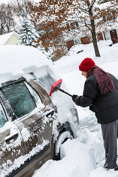istock Deep Snow Scraped Off Car Window By Winter Dressed Woman 530556335