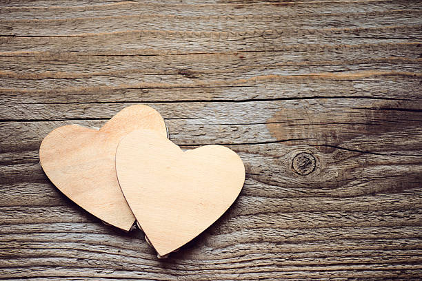 istock hearts on a wooden background 530558321