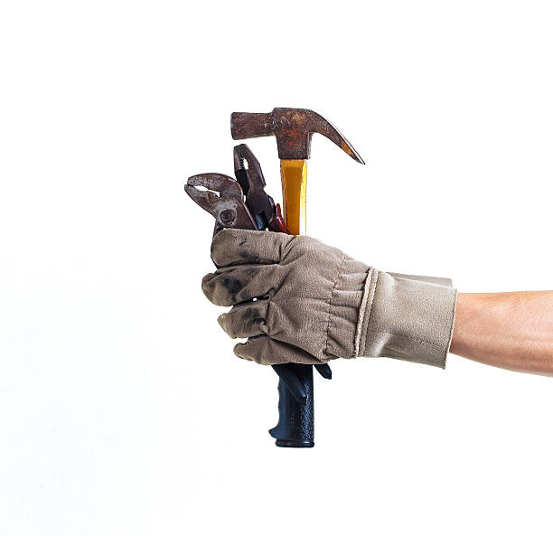 istock Worker holding pliers hammer and wrench for services isolated 530558451