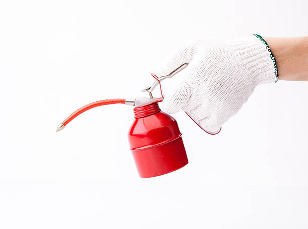 istock Worker holding lubricant oil can the image isolated on white 530558453