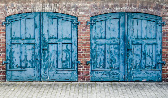 A Pair Of Heavy Old Doors On An Old Mews Or Street Of Stables Or  Row Of Carriage Houses