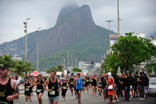 Rio de Janeiro, Brazil - December 9, 2012: People running city marathon race along Copacabana Beach, Rio de Janeiro, Brazil