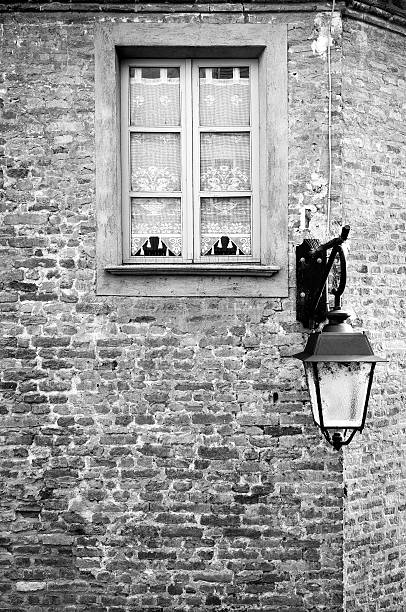 Old house wall with window and street lamp in a little village of the Langhe (in the Province of Cuneo, Piedmont).