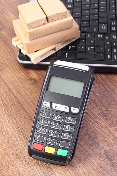 istock Payment terminal, laptop and small wrapped boxes on pallet 530561962