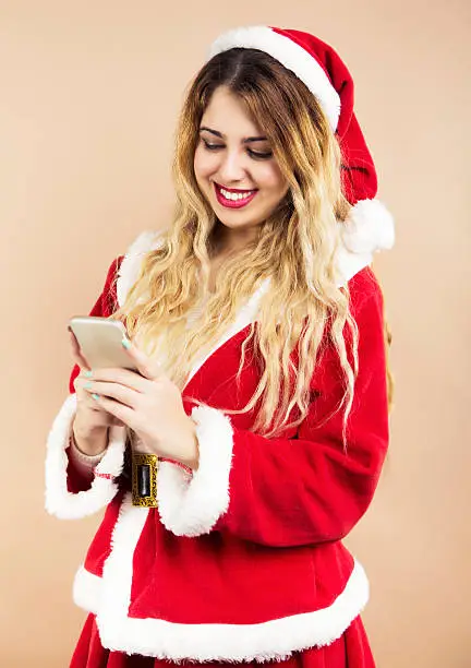 Happy Mrs.Claus text messaging with smart phone