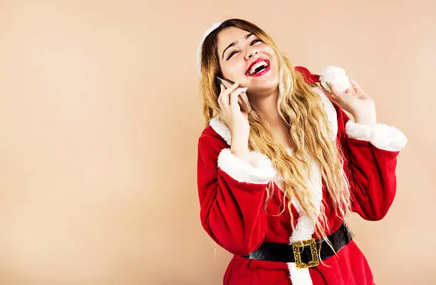 Happy Mrs.Claus laughing while talking on the phone