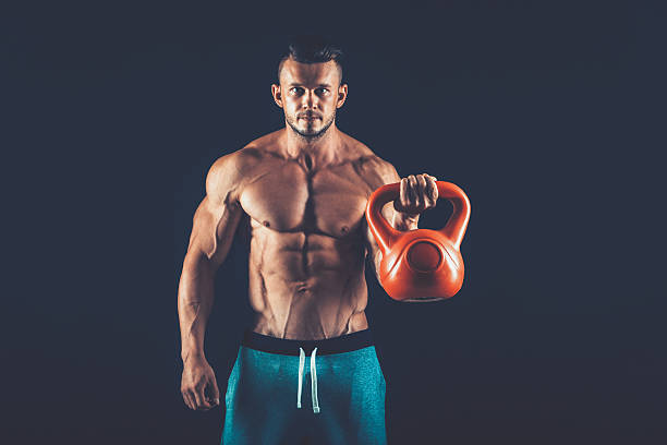 istock Fitness man doing a weight training by lifting  heavy kettlebell 530562036