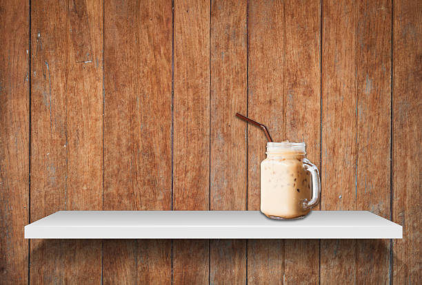Iced coffee on shelf on old wooden background