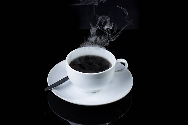 istock Cup of coffee with steam on black background 530562893