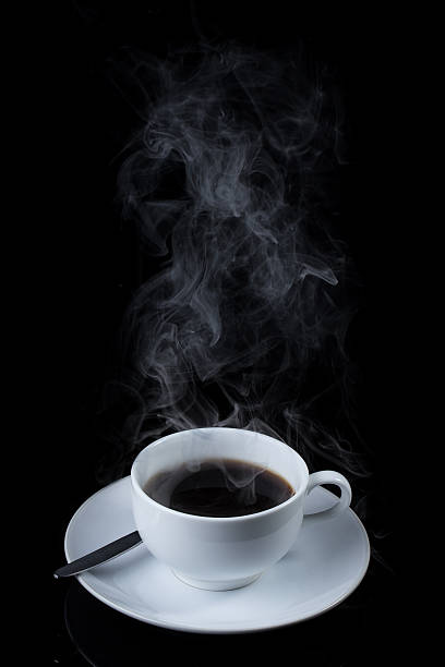 istock Cup of coffee with steam on black background 530562897