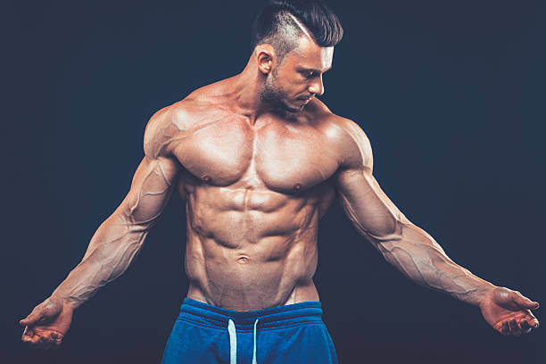 istock strong athletic man on black background 530563102