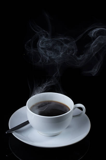 istock Cup of coffee with steam on black background 530563433