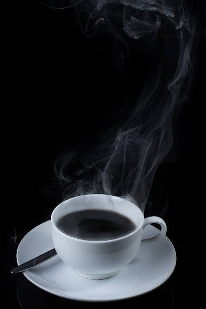 istock Cup of coffee with steam on black background 530563435