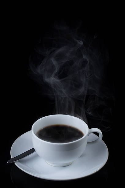 istock Cup of coffee with steam on black background 530563437