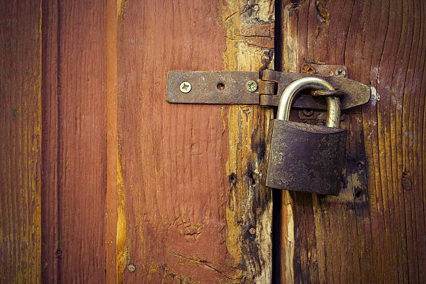 istock metallic lock on old wooden door 530564064