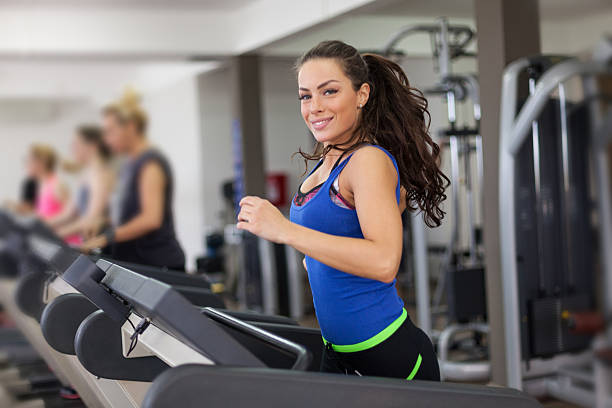 istock Beautiful brunette on a treadmill 530565074
