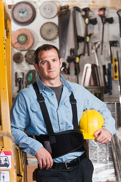 istock Man working in warehouse with hardhat and support belt 530566027