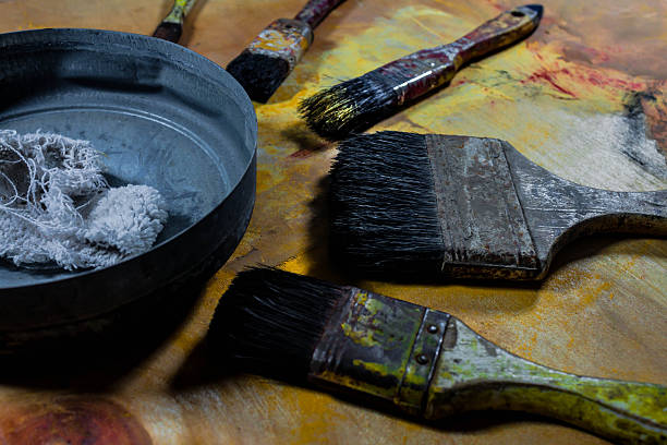 istock old grungy paint brushes on wood floor 530566160