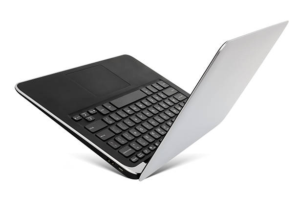 Flying aluminium laptop, isolated on a white background. stock photo