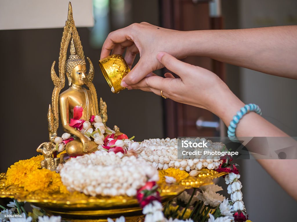 Pour water onto a Buddha statue Bowl Stock Photo
