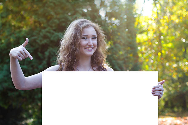 istock attractive young woman points to a billboard 530569601