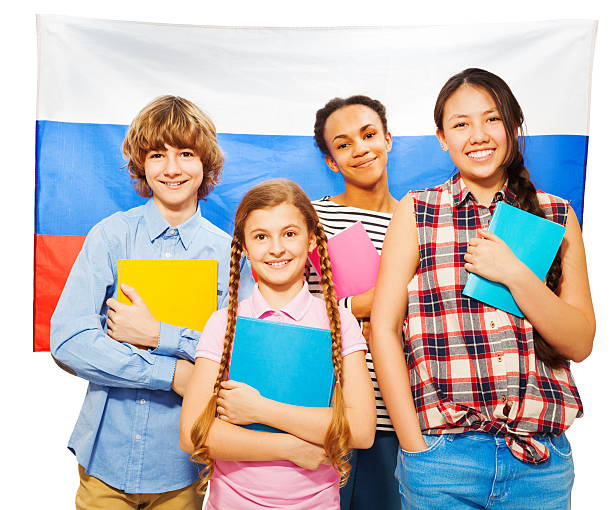 istock Four happy students standing against Russian flag 530569768
