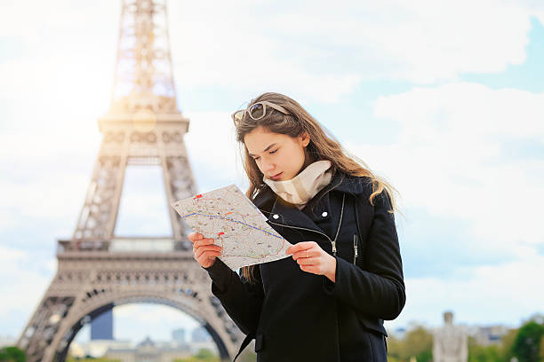 istock Tourist women in Paris holding a map 530571272