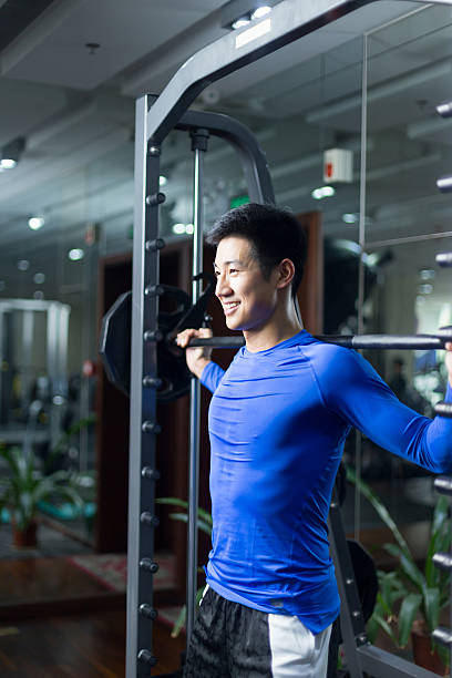 istock young asian man working out in modern gym 530572894