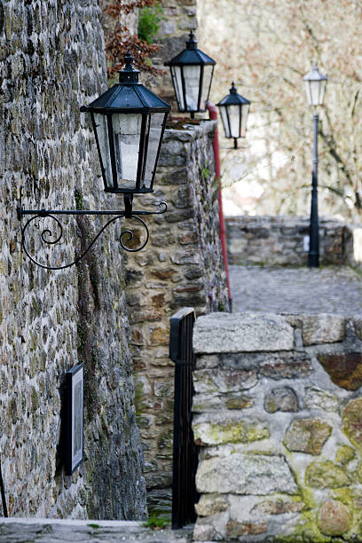 istock Historical street lamp on the stone wall 530573378