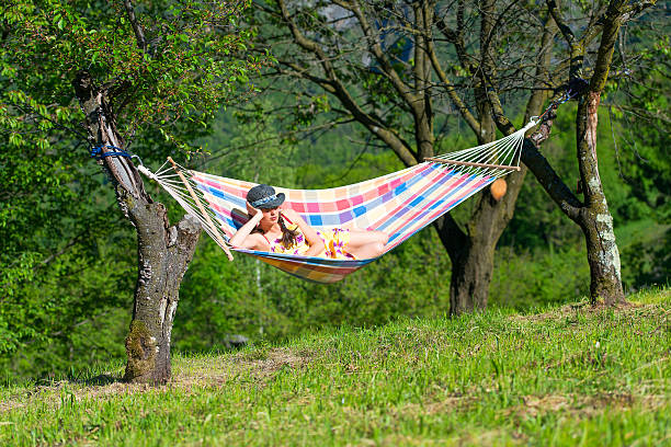 istock Woman sitting on hammock 530573900