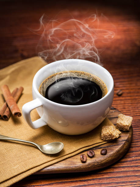 istock Cup of coffee and cane sugar cubes. 530574632