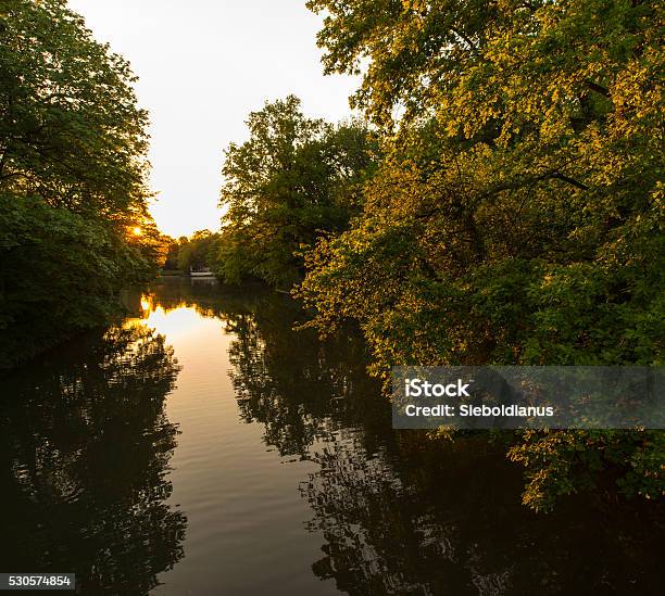 Sunset And Park Reflection In Lake Stock Photo - Download Image Now