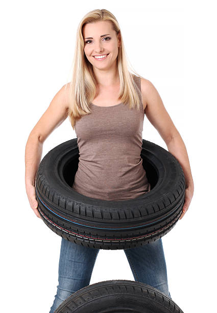 istock Tire. Girl with car wheels 530576264