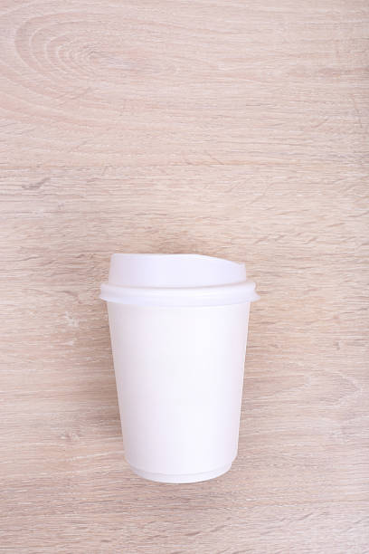 istock White paper coffee cup on wooden background 530576640