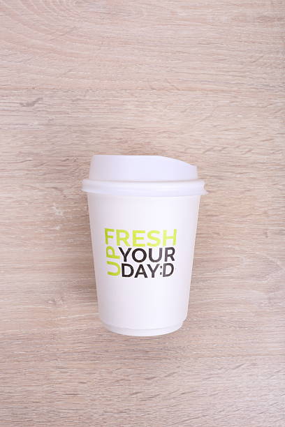 istock White paper coffee cup on wooden background 530576764