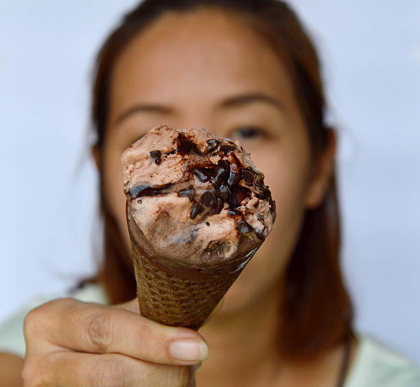 istock chocolate ice cream in front of woman 530577212