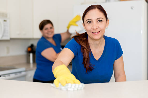 Cleaning team Smiling cleaning lady in yellow rubber gloves during work housekeeping staff photos stock pictures, royalty-free photos & images