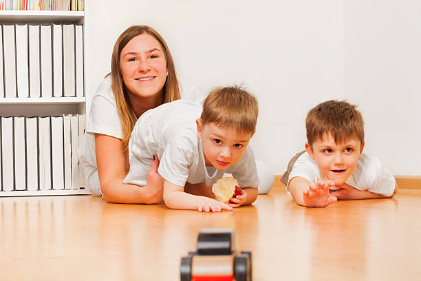 istock Young mother is playing with her two sons 530578250