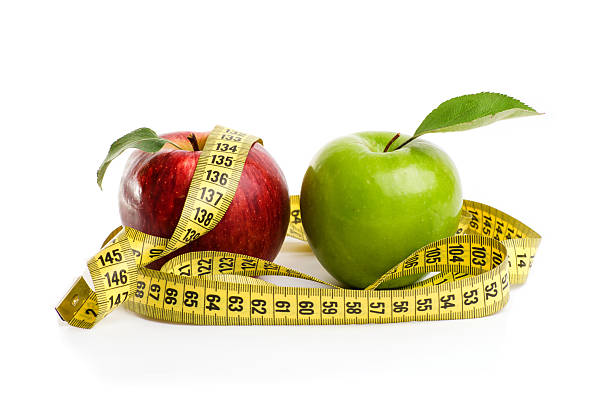 istock Apples, flowers and measuring tape. 530578676