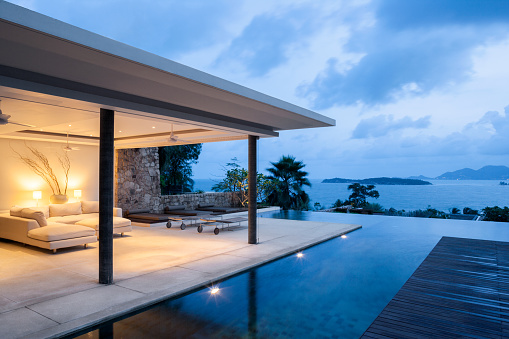 Luxury Island Home With Infinity Pool At Dusk.