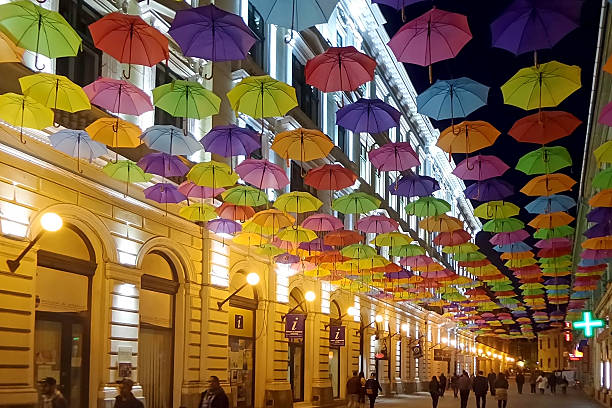 Timisoara, Romania - April 28, 2016: Street with colored umbrellas in Timisoara, Romania illuminated at night.