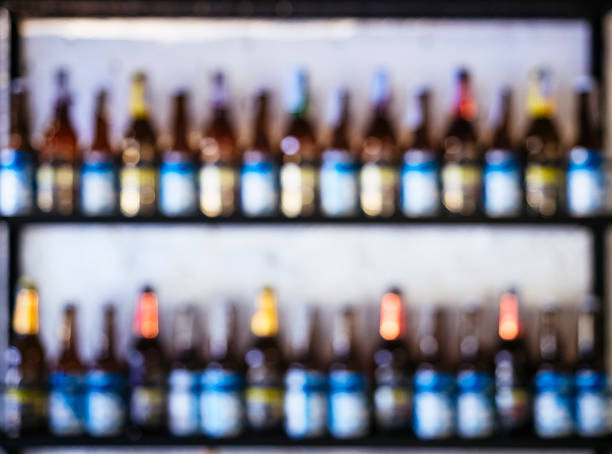 istock Blurred Wine Bottles on shelves Bar Background 530579272