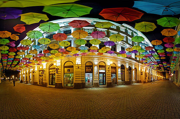Timisoara, Romania - April 29, 2016: Panoramic Surround with colored umbrellas in Timisoara on a street illuminated at night.