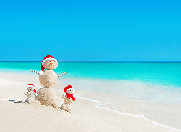 Snowmen family at beach in santa hats.Christmas concept Snowmen family at tropical ocean beach in santa hats. New Years and Christmas holiday in hot countries concept. anthropomorphic smiley face photos stock pictures, royalty-free photos & images