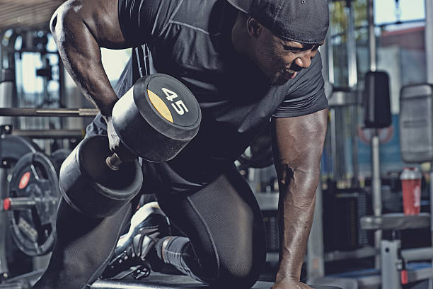 istock black male lifting dumbbells at a gym 530579954
