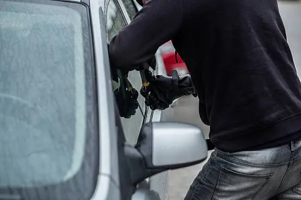 Photo of Car thief trying to break into a car