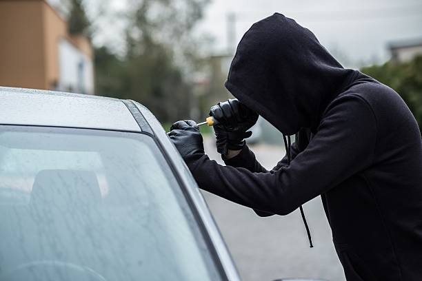 istock Car thief trying to break into a car 530580248