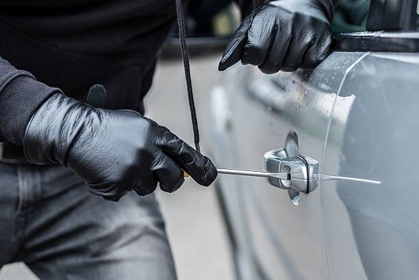 istock Car thief trying to break into a car 530580360