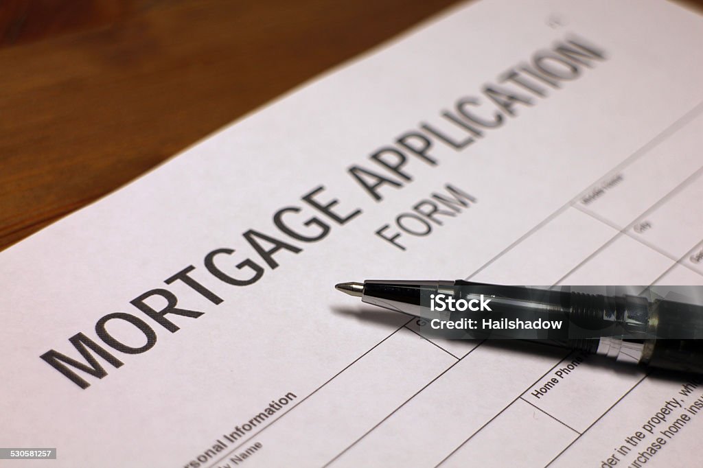 Mortgage Someone filling out Mortgage Application Form. Agreement Stock Photo