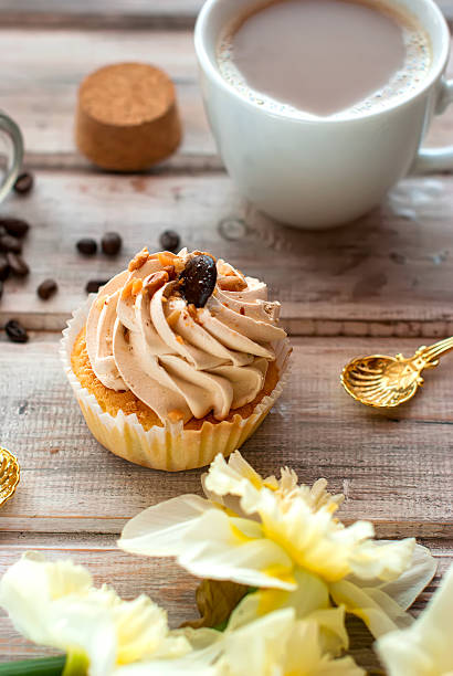 istock Cake and coffee cupand a bouquet of daffodils 530581430